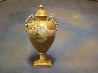 A 19th/20th Century Noritake porcelain twin handled vase decorated landscape with gilt banding (slight crack to inside of lid) raised on a  square base 16"