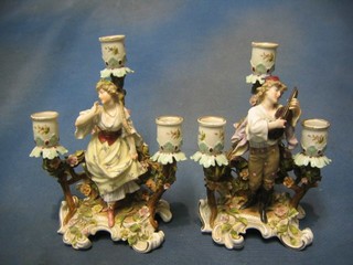 A pair of 19th Century Continental 3 light candelabrum supported by figures of Minstrel and lady 9 1/2" (r)