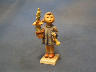 A Goebal figure of a girl with trumpet, plant pot and bird (chipped), base with V mark, 6"
