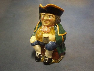 A Carltonware Toby jug in the form of a seated Toby Philpot with pint of beer 8"