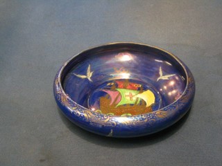 A Malingware circular blue lustre bowl decorated a galleon, base marked 3494 8"