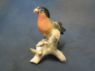A 20th Century Continental porcelain figure of  a seated bird with rose in beak, base marked ENS, 6"