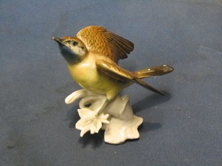 A 20th Century Continental porcelain figure of a bird with wings out stretched, base marked ENS, 4"