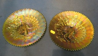 A pair of green Carnival glass bowls decorated peacocks 9"