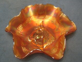 An orange Carnival glass bowl decorated ponies heads 8"