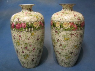 A pair of Edwardian pottery vases with floral decoration 11"