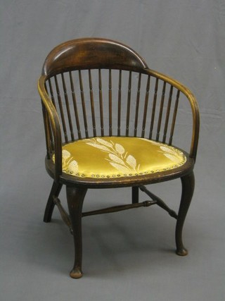 An Edwardian mahogany tub back chair with pierced turned bobbin back and upholstered seat, raised on cabriole supports united by H framed stretcher