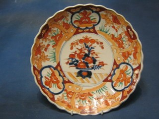 A 19th Century Japanese Imari porcelain plate with lobed rim, decorated flowers to the centre 12"