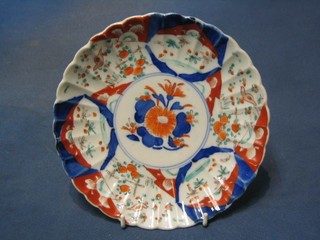 A 19th Century Japanese Imari circular porcelain plate with lobed body and floral decoration to the centre 8 1/2"