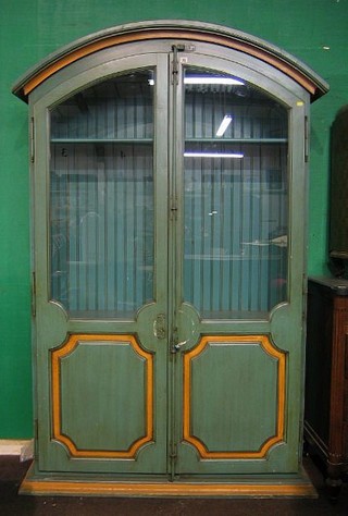 A green and gilt painted French style dome shaped display cabinet, fitted shelves enclosed by arched panelled doors 50" 
