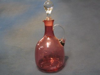 A "cranberry" glass ewer and stopper with clear glass handle 11"