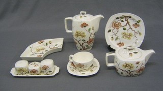A 74 piece Mid Winter Ming Tree pattern dinner/tea service comprising 2 hotwater jugs (slight crazing), large open jug 6", teapot, 2 cream jugs, lidded sucrier, oval twin section dish 9", 6 egg cups, condiment tray, salt, pepper and mustard, lidded sucrier, saucer boat, 12" circular plate (crazing), 6 dinner plates 10", 6 breakfast plates 9" (some crazing), 6 tea plates 8" (some crazing), 6 tea plates 6 1/2" (2 with firing damage), 8" oval dish, 7 1/2 dish, 6 cereal bowls 6" (1 chipped), 5" bowl, 6 pudding bowls 7" (1 chipped), 6 cups and 6 saucers (1 saucer cracked), 2 cracked cups, circular sugar bowl, 2 mugs and a 4 section dish