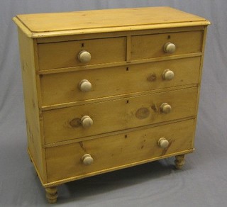 A Victorian stripped and polished pine chest of 2 short and 3 long drawers with tore handled, raised on turned feet 40"