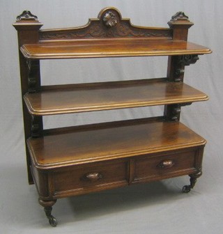 A Victorian carved figured mahogany 3 tier buffet, the base fitted 2 drawers and raised on bulbous turned supports with pierced brass castors 48"