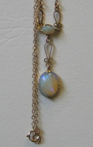A lady's opal pendant hung on a gold chain