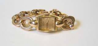A lady's 18ct gold cocktail wristwatch by the International Watch Co. on a gilt metal bracelet