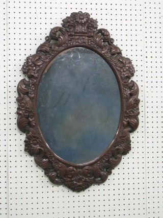 An oval plate mirror contained in a decorative frame 26"