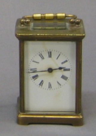 A carriage clock with enamelled dial (cracked) contained in a gilt metal case