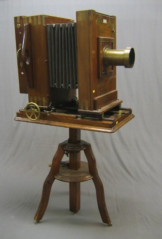 A 19th Century brass and mahogany plate, portrait photograph camera manufactured by Hunter-Penrose Limited, the brass lens by T B Heath, (slight dent to lens cover)