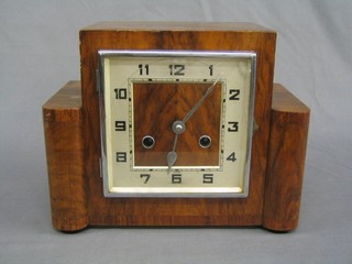An Art Deco 8 day striking mantel clock with square dial and Arabic numerals contained in a walnut case