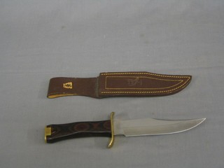 A Spanish reproduction Bowie knife with 7" blade, rosewood and brass mounted grip by Muela Albar complete with leather scabbard