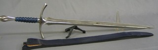 A reproduction 17th Century twin handled double edged sword with 36" blade contained in a blue scabbard