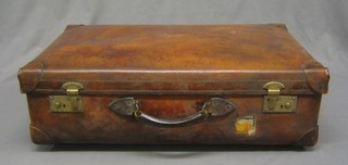 A leather suitcase by A W Dear of Hyde Park Corner with metal fittings
