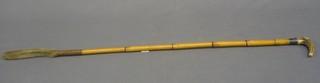 A 19th/20th Century bamboo riding crop with stag horn handle and silver band