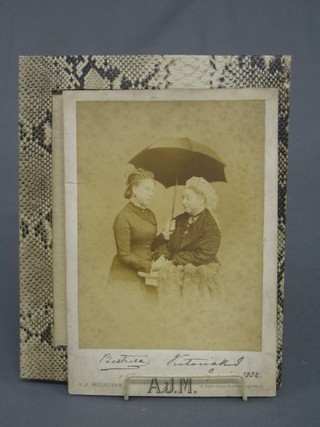 A Victorian black and white photograph of Queen Victorian and Princess Beatrix by A J Melhuish, signed Beatrix March 2 1882, the reverse with Napoleonic Library stamp  Carisbrook House Twickenham Park 10" x 7"