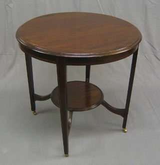 A circular Edwardian inlaid mahogany 2 tier occasional table, raised on square tapering supports ending in brass caps and castors, 29"