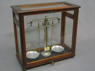 A pair of laboratory scales by Loerting Ltd London, contained in a mahogany case