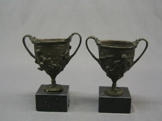 A pair of fine quality 19th Century bronze twin handled urns decorated mythical beasts raised on square bases 8"