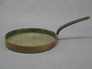 A 19th Century circular copper saucepan with iron handle 11"