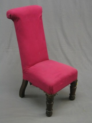 An  oak framed Pri Dieu chair upholstered purple material, raised on turned supports