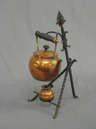 A Victorian copper tea kettle raised on a wrought iron stand complete with burner (f)