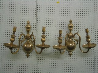 A pair of Dutch style brass twin light wall lights