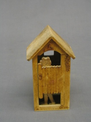 A humerous pokerwork model of a bathing machine with standing lady 6"