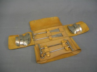 A gentleman's chromium plated 6 piece riding accoutrement set comprising boot hooks, button hook, shoe horn and pair of boot shapers?, contained in a leather case by Tom Hill