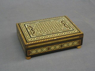 A Moorish hardwood jewellery box with musical box movement 7"