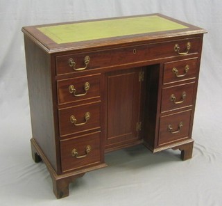 A Georgian style kneehole pedestal desk with inset tooled leather writing surface, fitted 1 long drawer, the pedestal fitted a cupboard flanked by 6 drawers raised on bracket feet 34"