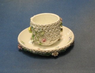 A 19th Century Continental porcelain cup and saucer with floral encrusted decoration (f and r)