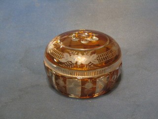 A circular Bohemian etched amber glass powder bowl and cover 6 1/2"