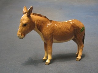 A Beswick figure of a standing donkey 4", base marked Beswick England and with Beswick label