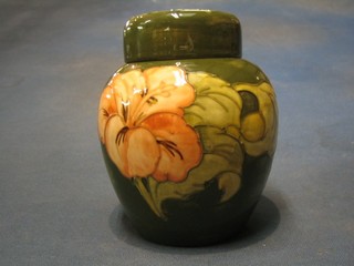 A Moorcroft coral hibiscus green glazed ginger jar and cover, the base with signature mark and paper label - Appointment to the Late Queen Mary, incised 5 to the base, 6"