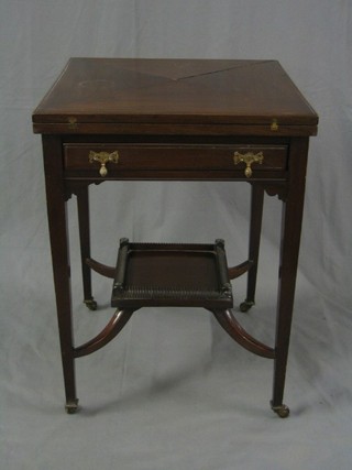 An Edwardian mahogany envelope card table fitted a frieze drawer and with square undertier, raised on square tapering supports 21"