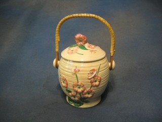 A Malingware pink lustre and floral decorated biscuit barrel and cover with wicker handle, base marked Maling England CJ84B, 8"