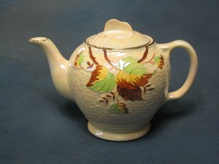 A circular Rington's Malingware teapot with floral decoration (lid cracked)