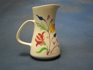 A cylindrical Poole Pottery jug with floral decoration, the base with rubber stamp mark, marked DNR 6"