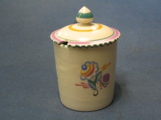 A cylindrical Poole Pottery preserve jar and cover with floral decoration, the base impressed Poole England and incised 490 3"