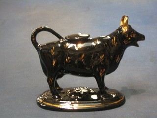 A 19th Century black glazed Staffordshire cow creamer